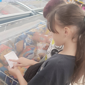 Dziewczynka przygląda się towarom w zamrażarce