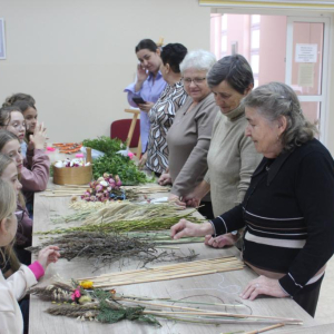 Prowadzące warsztaty człnkinie KGW wskazują na materiały przygotowane na palmy wielkanocne