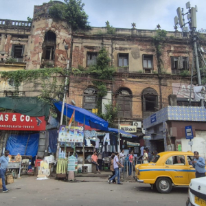Widok na ulicę jednego z miast Indii, stary budynek w tle.
